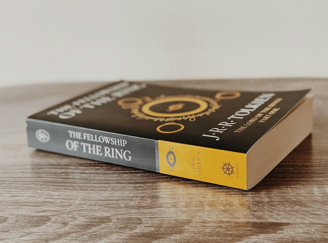 Stack of hardcover books on a wooden table