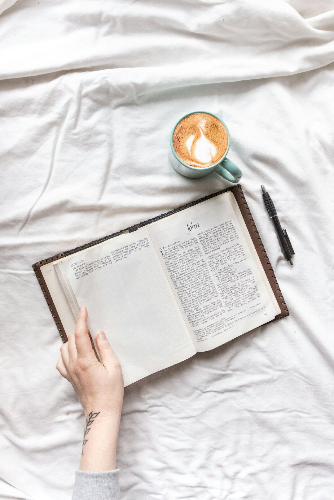 Hand writing in a notebook with a pen