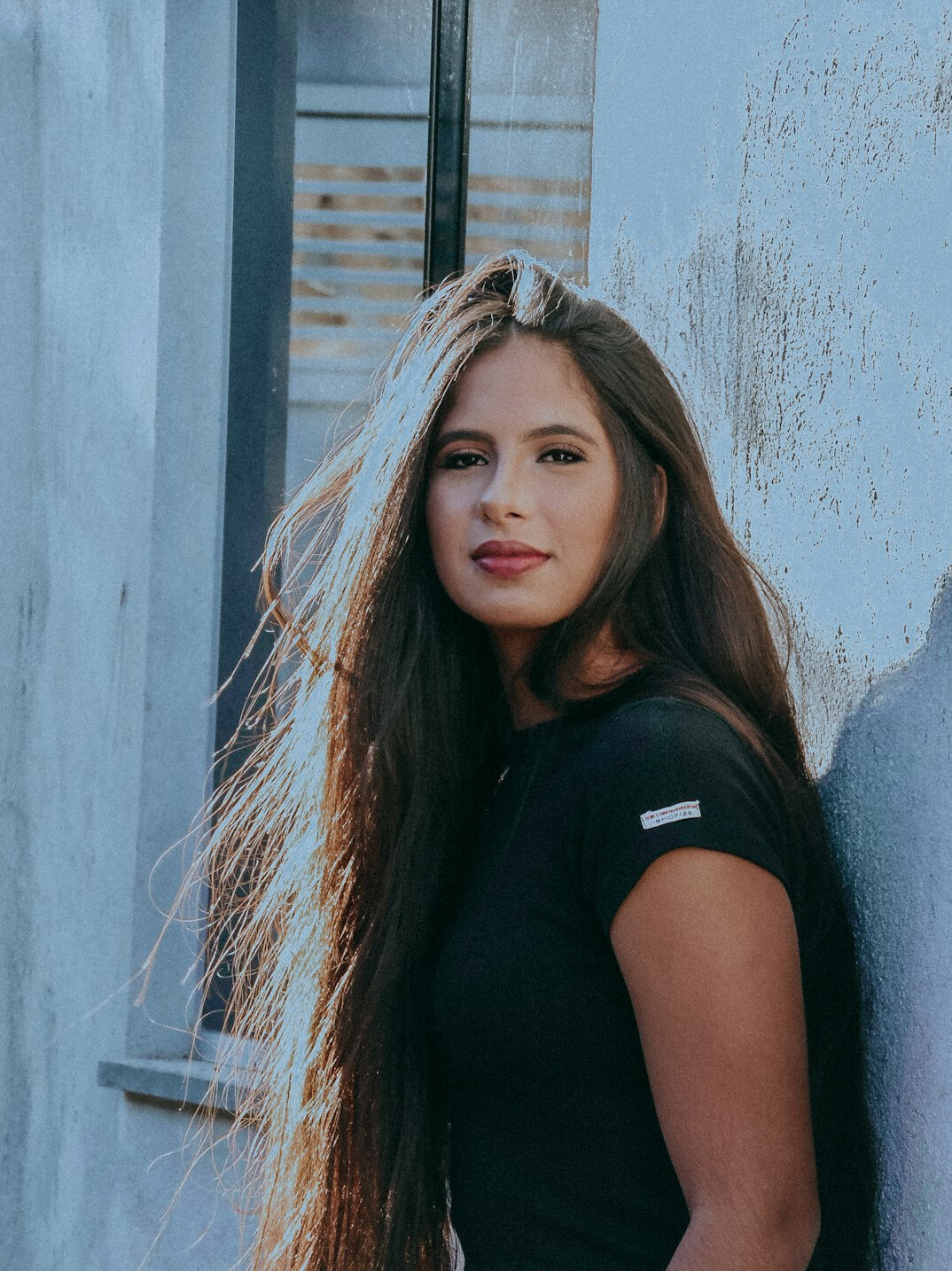Portrait of a woman with long hair looking at the camera