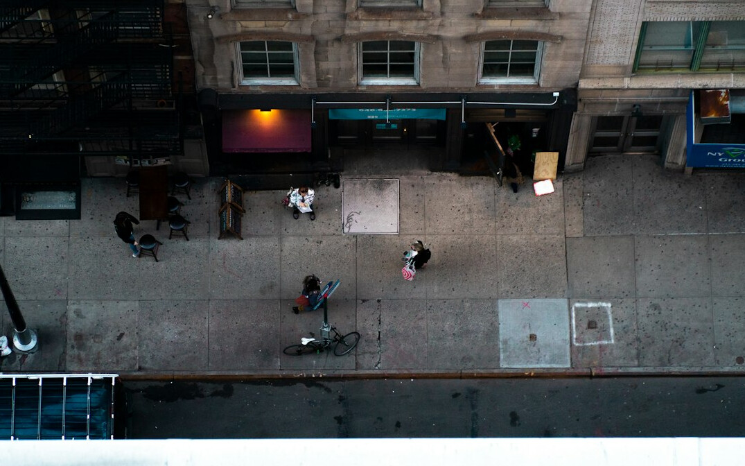 Quiet city street seen from above with distant pedestrians