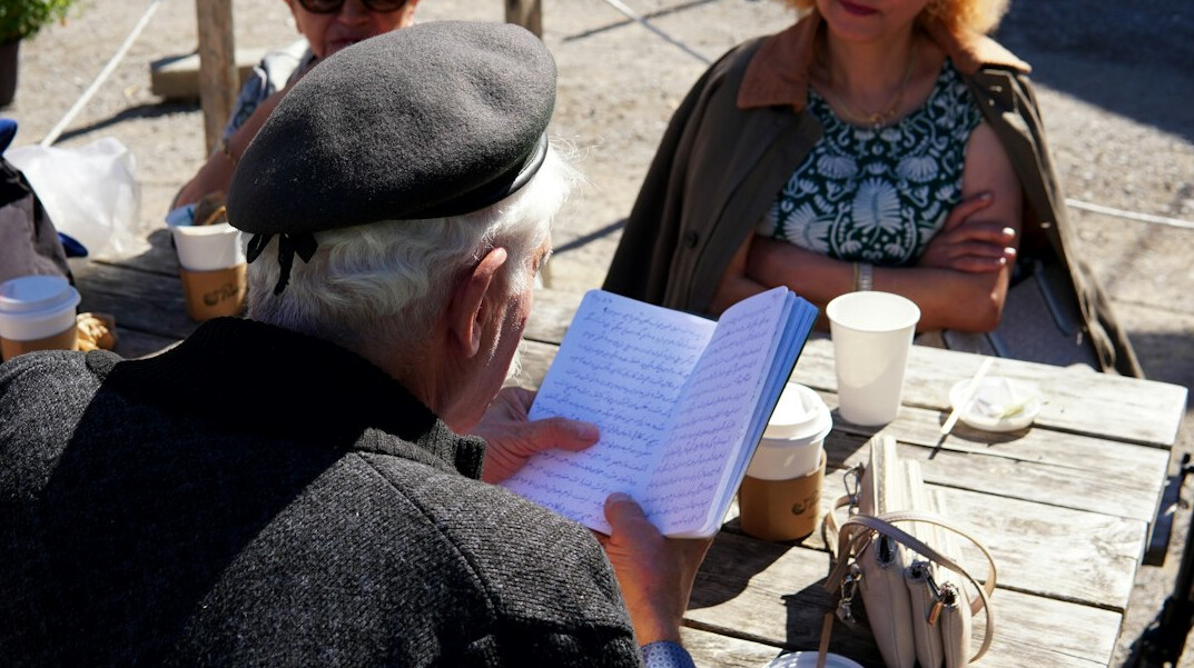person reading book in cafe
