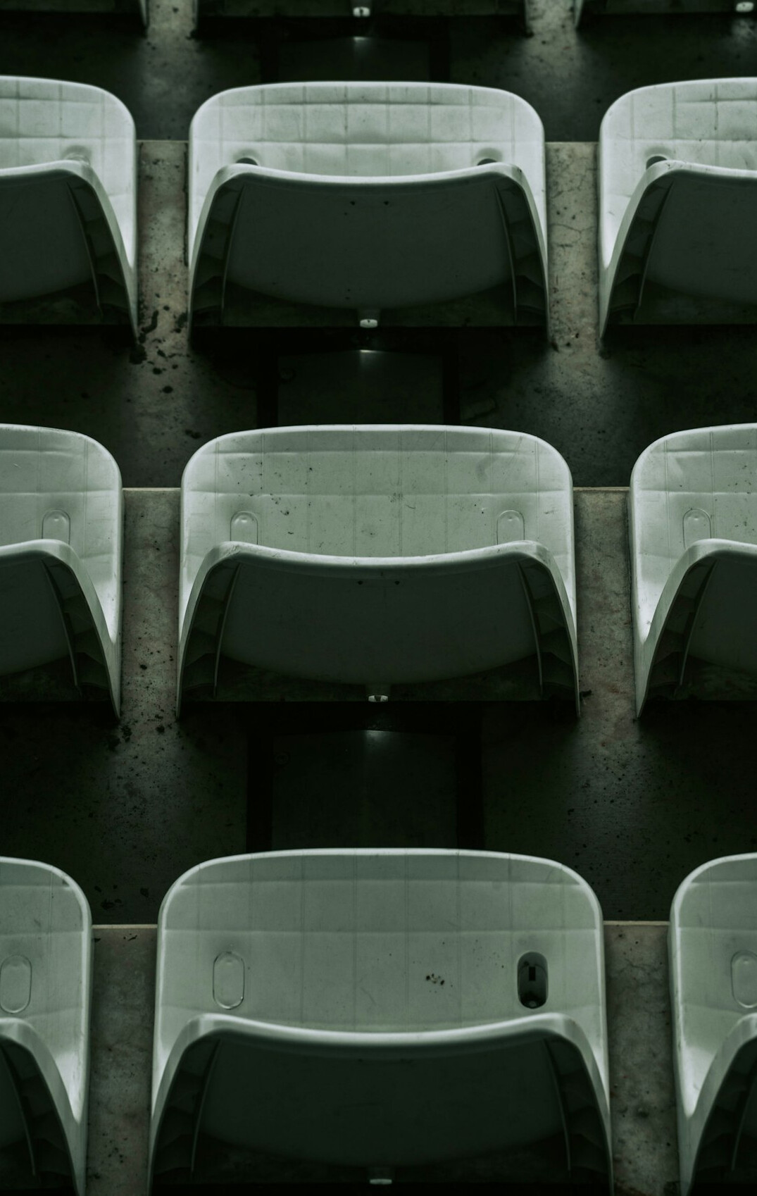 Rows of empty theater seats in dim light