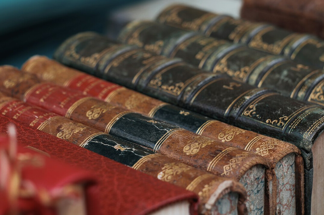 Old books with worn leather bindings